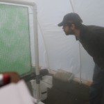 Facutly members examines creen of green matting in haze of fog