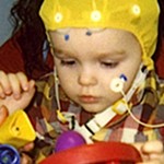 Child in autism study plays with toys