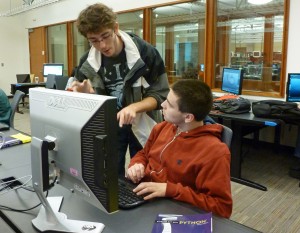 Teaching assistant works with student.