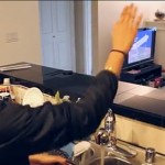 A hand gesture changes the TV channel.