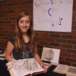 Molly Knopf, 11, a student in the UW Summer Youth Programs class on book arts, shows off her creation, made with wire, papier-mâché and a worn-out book.