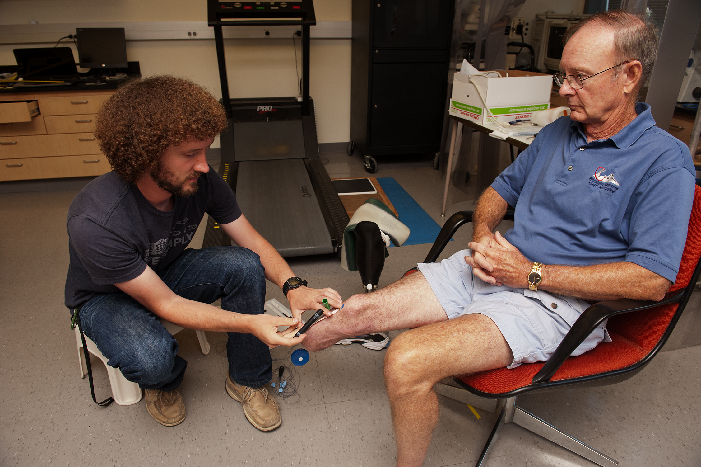 Measuring to place electrodes on leg.