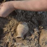 Students carefully excavate a complete vessel — this time, a Roman period juglet, possibly an oil container. After excavation, the soil in the interior of the vessel is sent for soil analysis at the Weizmann Institute in Israel. This analysis is then able to reveal the original contents of the vessel at the UW's Tel Dor archaeological site.
