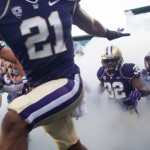 Huskies run onto the field.