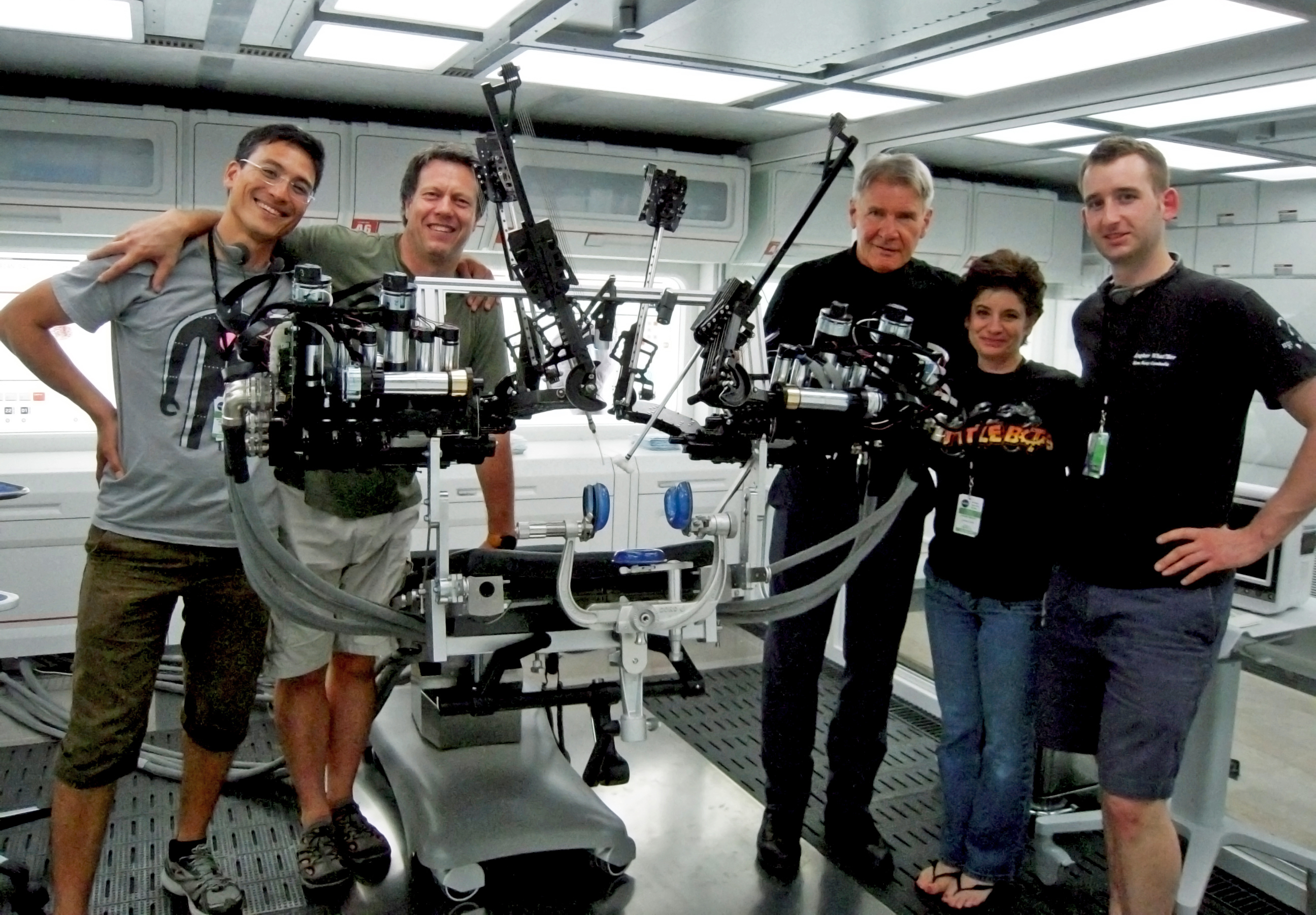 On the movie set with the University of Washington’s Raven II surgical robot. From left to right: Hawkeye King, director Gavin Hood, Harrison Ford, robotics expert Joanne Pransky and Lee White.