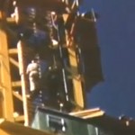 A man works on construction of the Space Needle.