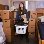 Student Heather Huizenga gets ready to leave her Terry Hall room, having packed her belongings in boxes. When she comes back from holiday vacation to begin winter quarter, her stuff will await her in a room in the new Lander Hall.