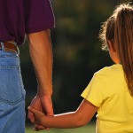 father holding daughter's hand