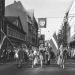 A black and white photo of a Baltica Folklore Festival procession in Riga, Latvia in July 1988.