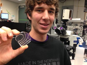 Student Chris Burfeind holds the device in his hand.