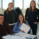 students at table with papers