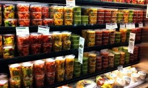 a refrigerator section at a grocery store containing fruit