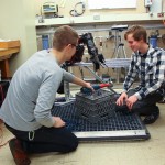 Undergraduates students work on instrumentation with the BluHaptics team.