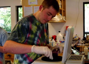 Student loads sample onto equipment