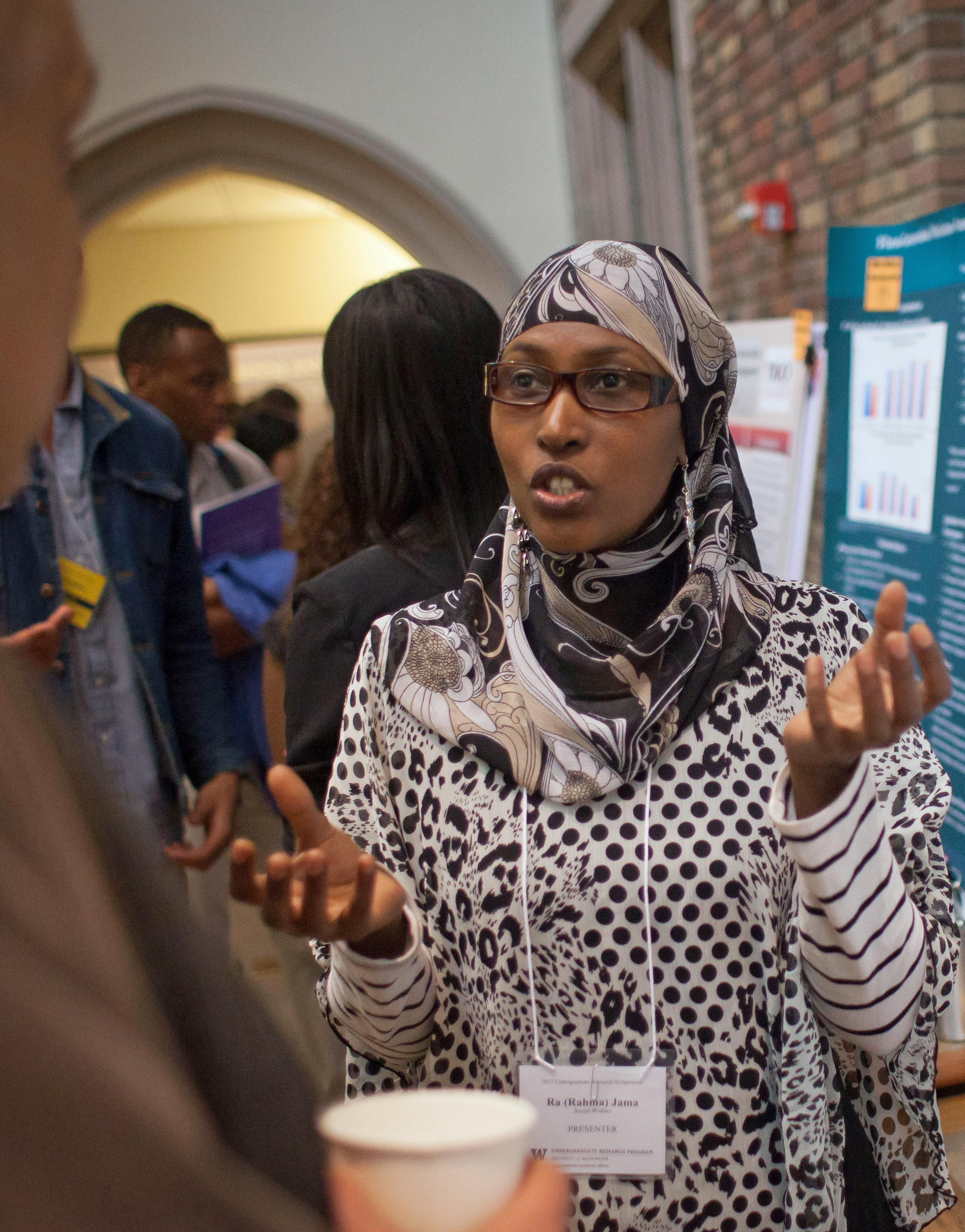 A student stands by posters explaining work