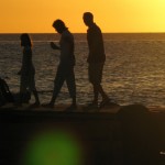 A family walks on the beach together.