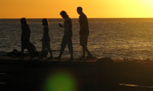 A family walks on the beach together.