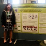 Mollie Holmberg stands next to her poster