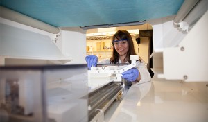 UW staff scientist Arielle Steger is shown working with a large-scale electrospinning machine at the UW.