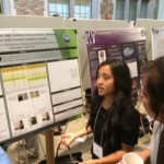 Trinh Ha, an incoming freshman who will study engineering, talks with visitors at the UW Summer Undergraduate Research Poster Session Wednesday, Aug. 20, 2014.
