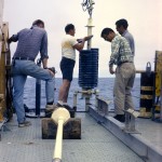 people placing corer on boat
