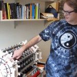 UW physics graduate student Nikola Whallon shows off a Legos version of the Atlas detector.
