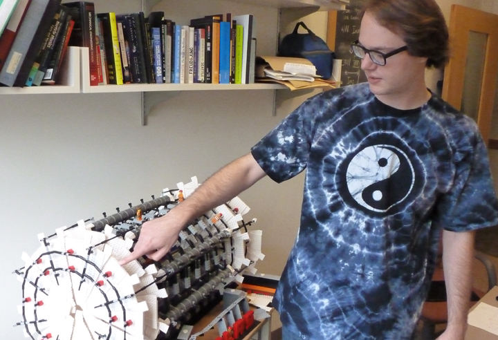 UW physics graduate student Nikola Whallon shows off a Legos version of the Atlas detector.