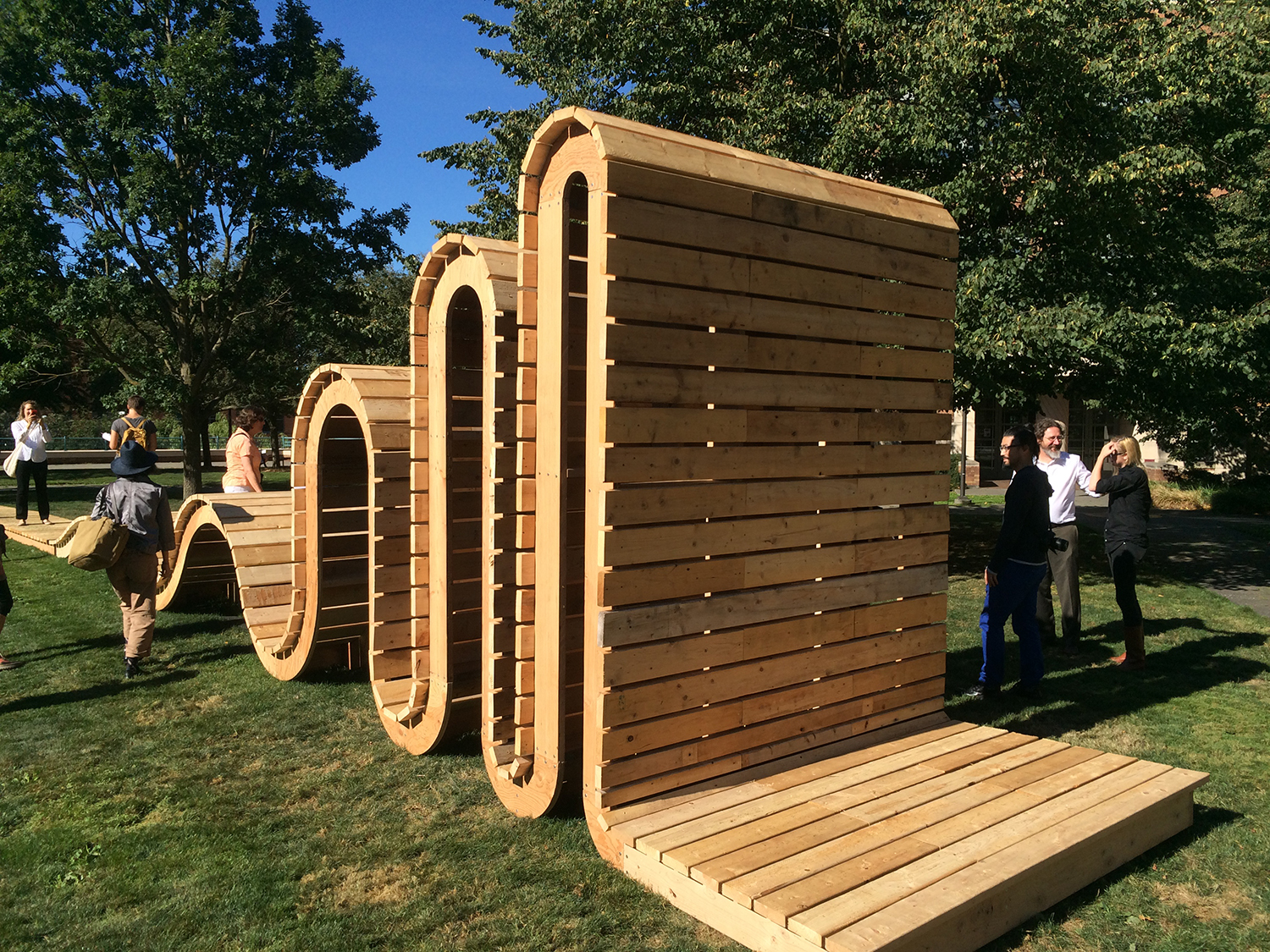 Press and visitors examine "Wave Sine," a sculpture by W.Scott Trimble during a preview of the Mad Campus exhibition on Thursday, Sept. 9.