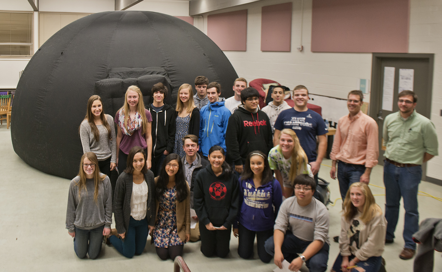 Students at Sammamish High School stand with the UW's tent-like mobile planetarium the evening of Wed., Oct. 29, 2014, before climbing inside to give their own planetarium presentations. At the far right is UW volunteer Dave Brodhead, and next to him is Oliver Fraser, UW lecturer in astronomy.