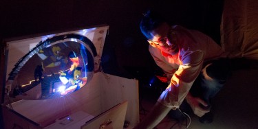 Oliver Fraser, UW astronomy lecturer, sets up for the evening at Sammamish High School in Bellevue. The convex mirror at left was an innovation by student Justin Gaily, who has since graduated.