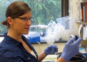 Woman at lab bench holds instrument