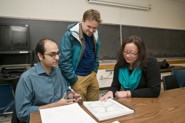 Doctoral student Ahmer Arif, left, gets feedback from co-instructors Jeremy Kayes and Charlotte Lee.