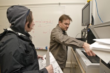 Graduate student Susan Evans, left, works with co-instructor Jeremy Kayes to scan her comics into a digital format.
