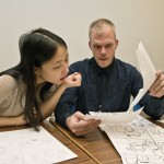 Undergraduate students Xiangyi (Anne) Zheng, left, and Daniel Aldridge give feedback on each other's comics at a recent class.