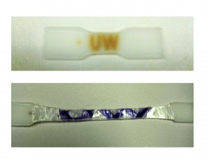two plastic tabs, one with "UW" printed in purple