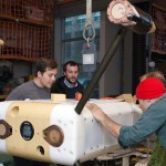 From left to right: UW researchers Ben Rush, Nick Michel-Hart, James Joslin and Paul Gibbs prepare to test the monitoring device underwater in a tank on campus.