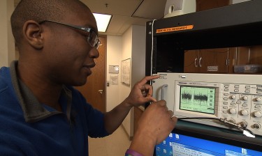 Darrin Howell, a UW postbaccalaureate researcher in biology, records the electrical activity sent up and down the spinal cord of moths.