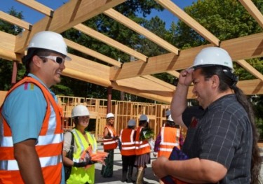 Intellectual House Director Ross Braine, left, and Scott Pinkham, an American Indian Studies lecturer, at a log blessing ceremony in August 2014.