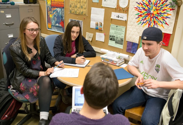 Elwood meets with students Stella Jones, left, Jackie Divita and Kendal Dressel to discuss their project.