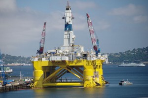 yellow oil rig with Seattle in background