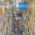 Scientists at the European Organization for Nuclear Research are dwarfed by the Atlas particle detector, part of the Large Hadron Collider.