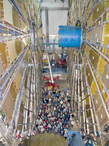 Scientists at the European Organization for Nuclear Research are dwarfed by the Atlas particle detector, part of the Large Hadron Collider.