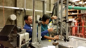 UW Aeronautics and Astronautics professor Uri Shumlak and student Bonghan Kim work on an earlier prototype of the Z-pinch device.