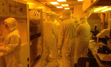 Photograph of UW students taking a microfabrication class get hands-on training in cleanroom laboratory techniques at the Washington Nanofabrication Facility.