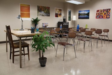 A non-stereotypical computer science classroom decorated with plants and nature posters.