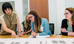 UW design professor Karen Cheng, left, consults with (from left) Erin Kendig, editor of ARCADE magazine and Angela Socci and Carrie Jones of the Seattle Police Department. Cheng and colleagues were invited to present information on the infographics they created from publicly available City of Seattle data.