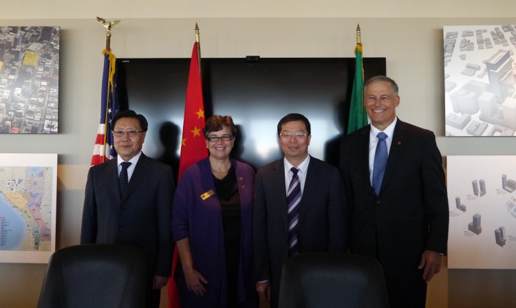From left: Wang Dongming, Ana Mari Cauce, Qiu Yong and Jay Inslee at the signing ceremony Sept. 22.