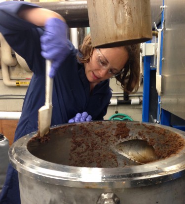 Shannon Ewanick collects products exiting the pretreatment reactor after the reactions have fractioned the biomass.