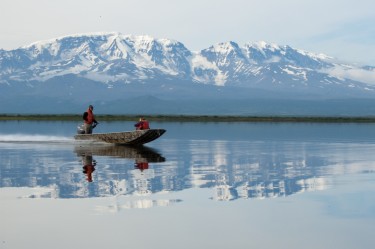University of Washington researchers pass in front of volcano Mt. Veniaminof while traversing Black Lake on their way to the Alec River.