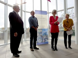 four people in front of banner